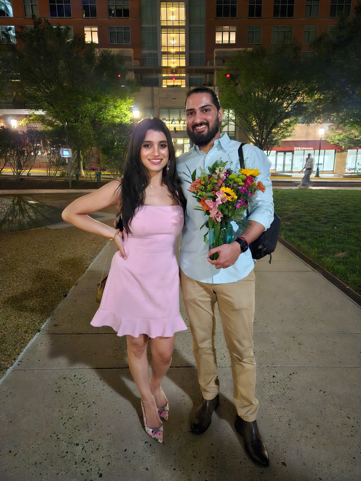 Jennifer and Samir with a bouquet of flowers